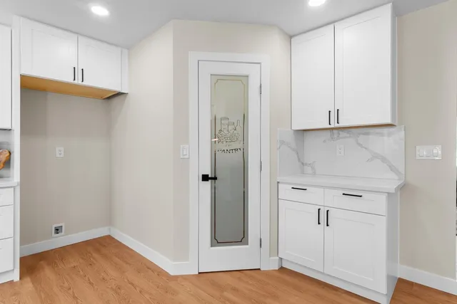 a view of an empty room with closet and a window