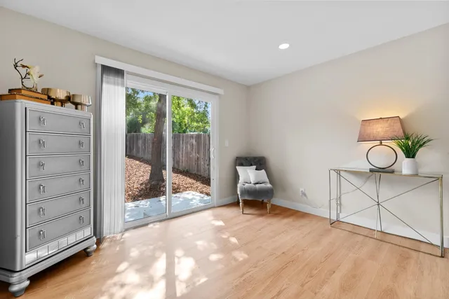 a view of a bedroom with cabinet mirror and windows