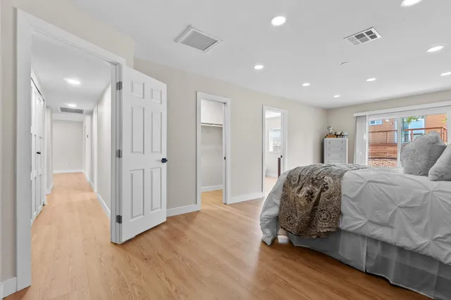 a spacious bedroom with a bed and a walk in closet