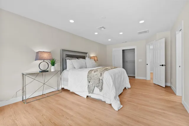 a bedroom with a bed and a table