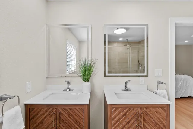 a bathroom with double sink and a mirror