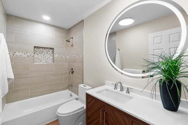 a bathroom with a sink a toilet and a mirror