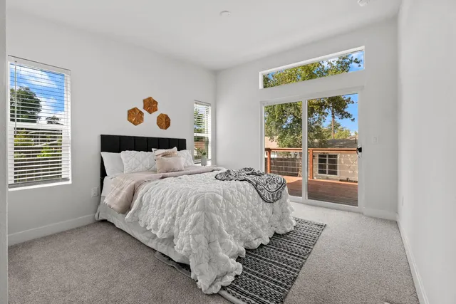 a bed sitting in a bedroom next to a window
