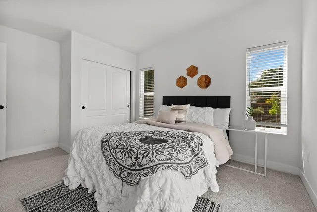 a bedroom with a bed and a window