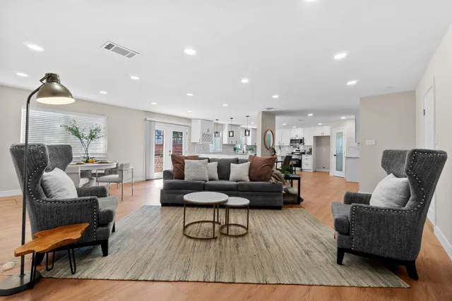 a living room with furniture and a lamp