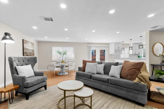 a living room with furniture and wooden floor