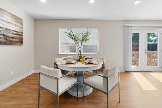 a view of a room with a table and chairs