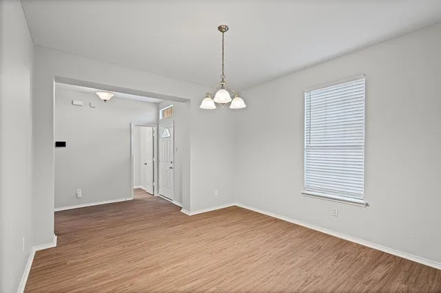 a view of a room with wooden floor and windows