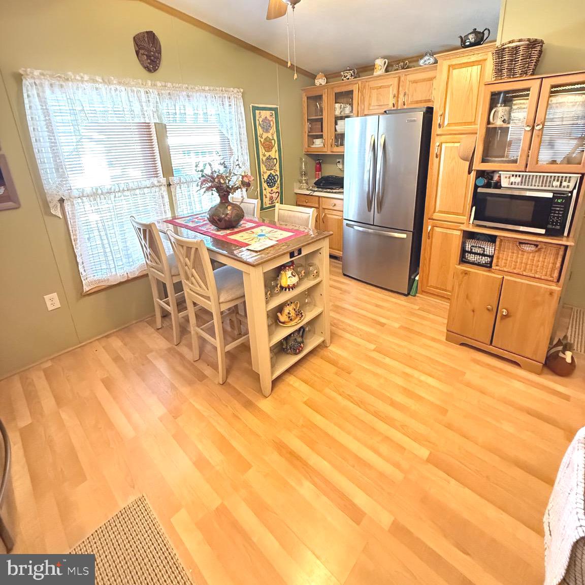 184 5th Avenue Media, PA 19063 - Photo 15 of 30 a kitchen with stainless steel appliances a stove a refrigerator a sink a dining table and chairs with wooden floor