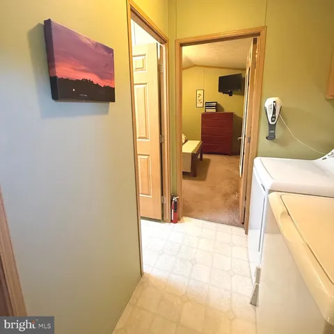 a bathroom with a tub shower and mirror