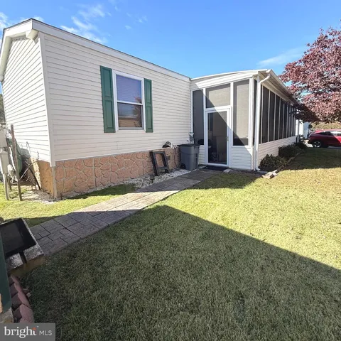a view of a house with swimming pool and sitting area