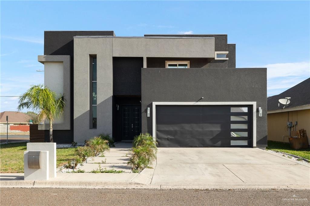 Contemporary home with driveway and stucco siding