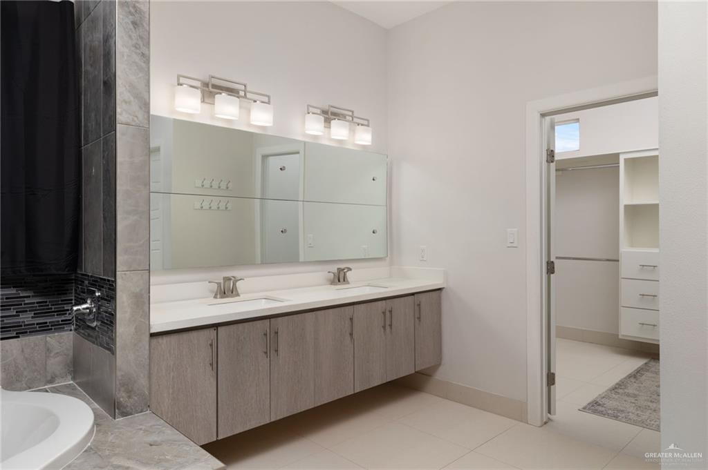 801 East Azucar Avenue Pharr, TX 78577 - Photo 11 of 19 Bathroom with a sink, baseboards, double vanity, and tile patterned floors