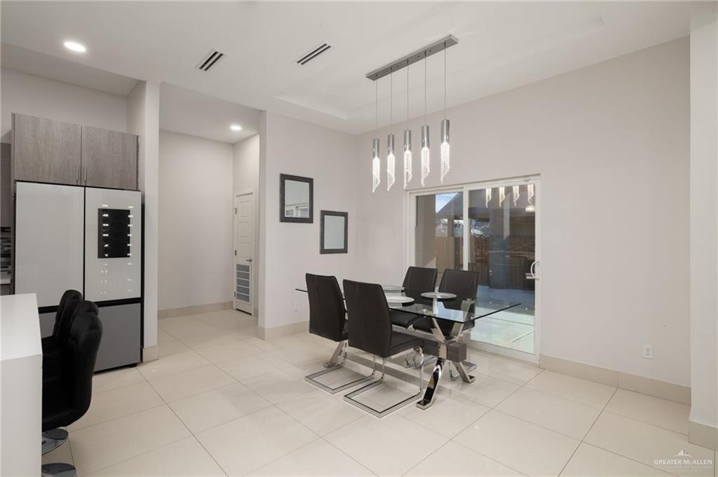 801 East Azucar Avenue Pharr, TX 78577 - Photo 5 of 19 Dining space featuring light tile patterned floors, visible vents, and baseboards