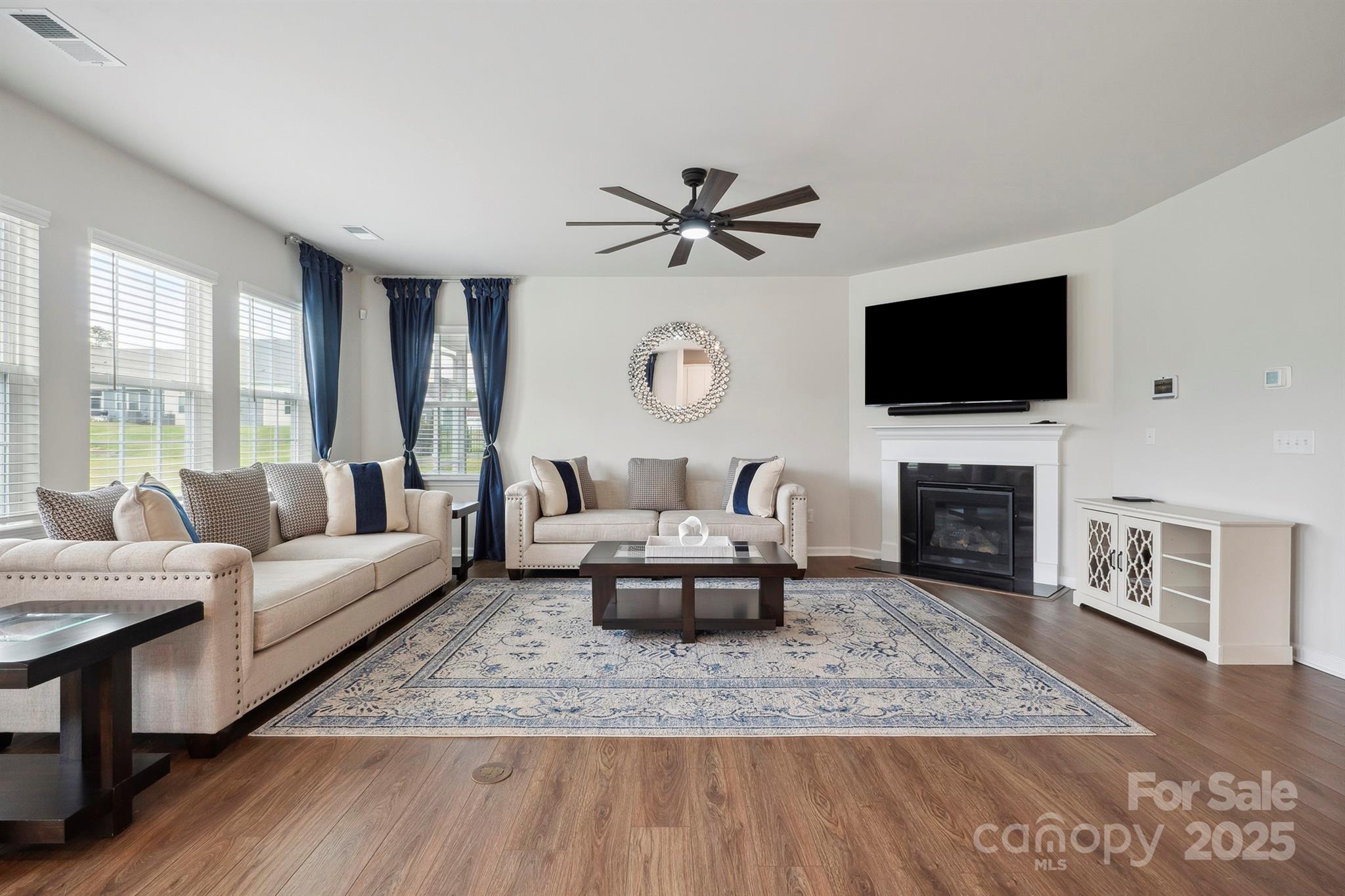 4015 Havenport Circle Fort Mill, SC 29708 - Photo 2 of 47 a living room with furniture a fireplace and a flat screen tv
