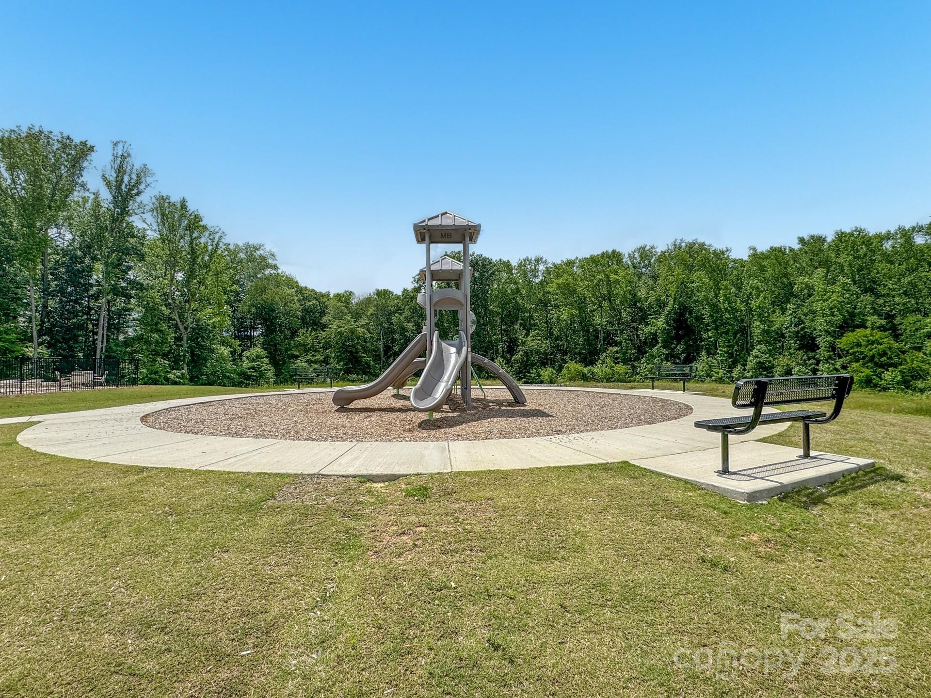 4015 Havenport Circle Fort Mill, SC 29708 - Photo 44 of 47 a view of a swimming pool with a bench and trees in the background
