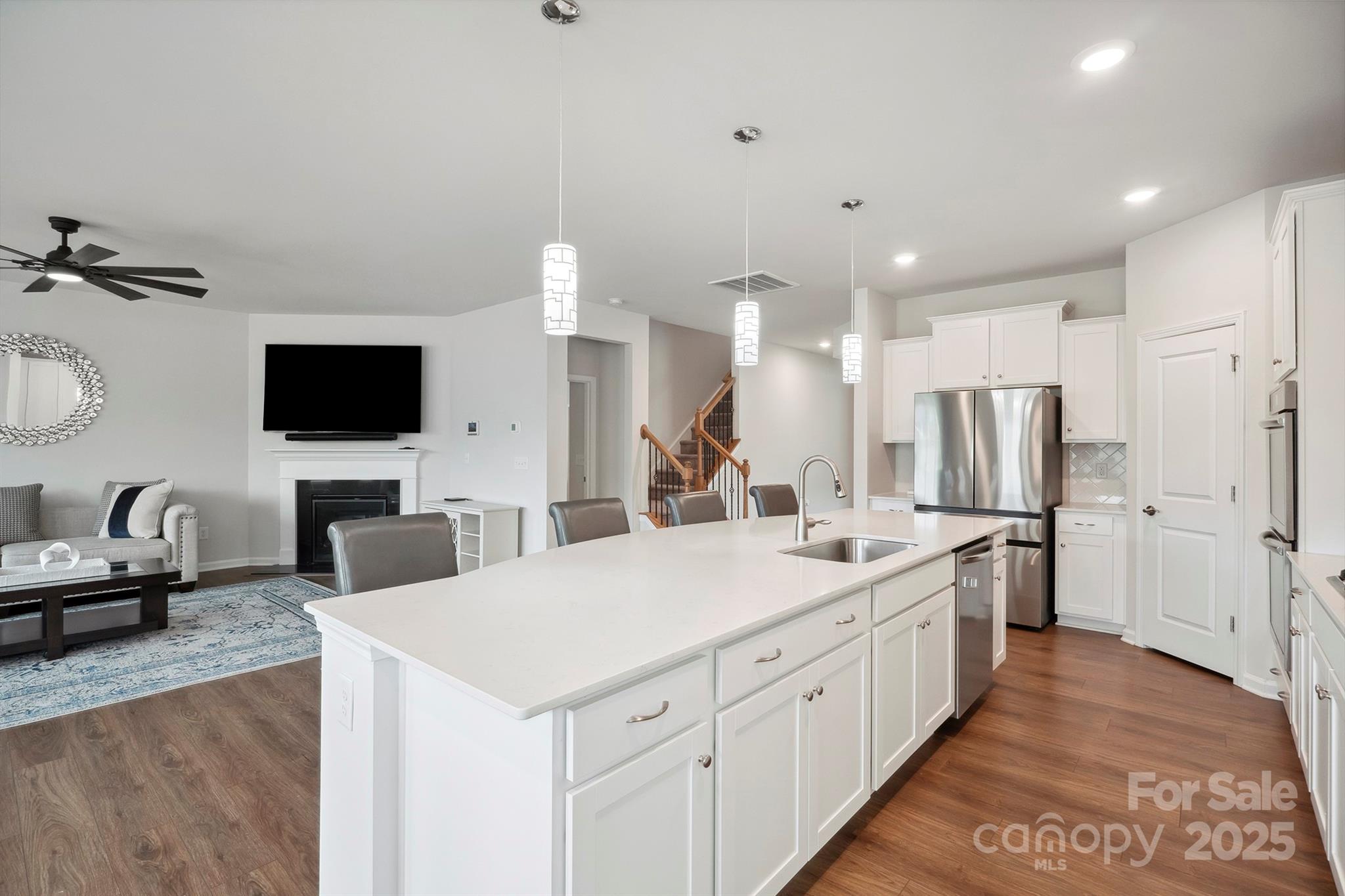 4015 Havenport Circle Fort Mill, SC 29708 - Photo 10 of 47 a large white kitchen with a stove a sink a refrigerator and a flat screen tv