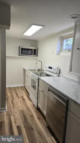 a spacious bathroom with a sink and a mirror