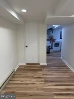 a view of a hallway with a kitchen