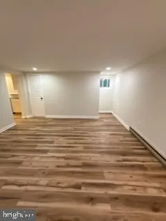 a view of a room with wooden floor