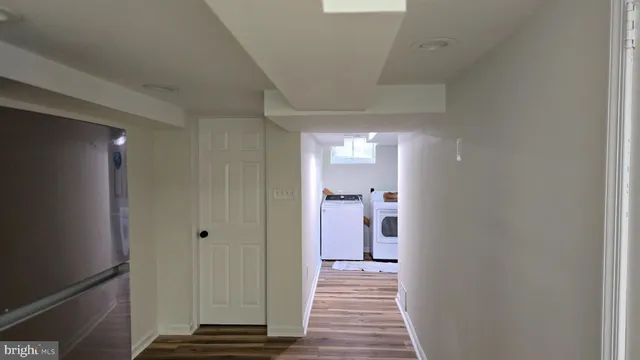 a view of a room with wooden floor