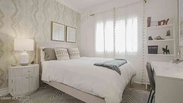 a bedroom with a bed and a chair