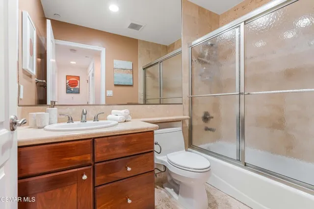 a bathroom with a toilet a sink and shower