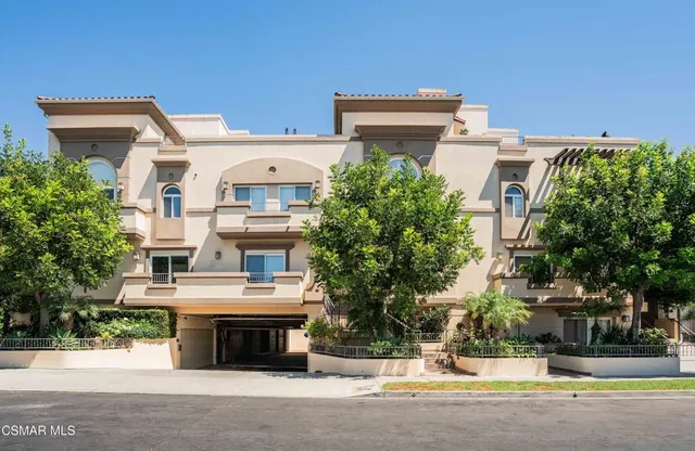 front view of a building with a garden