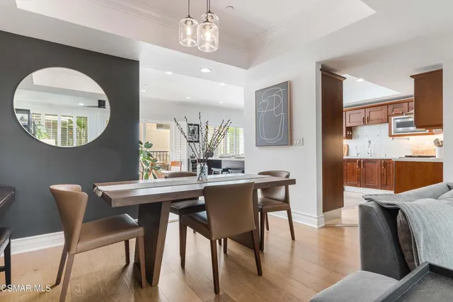 a view of a dining room with furniture and a chandelier