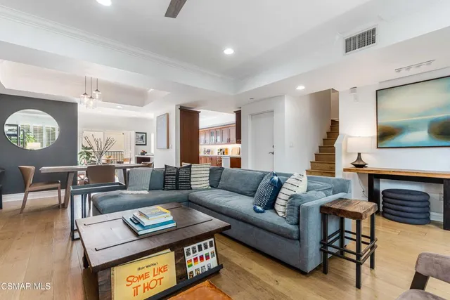 a living room with fireplace furniture and a wooden floor