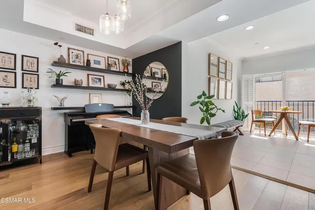 a view of a dining room with furniture and a chandelier