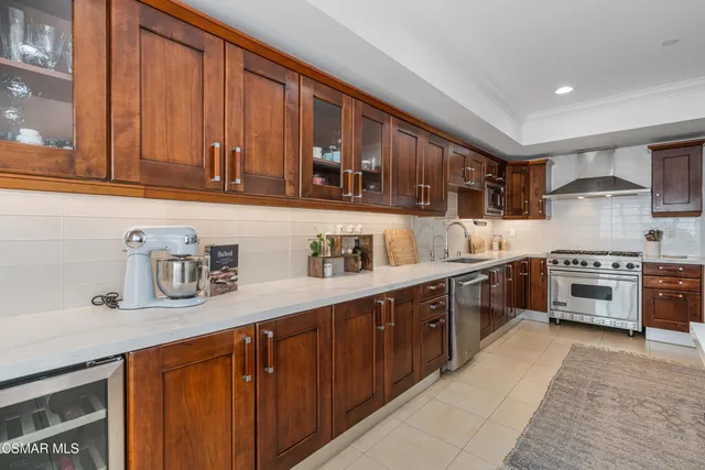a kitchen with stainless steel appliances granite countertop a sink stove and cabinets