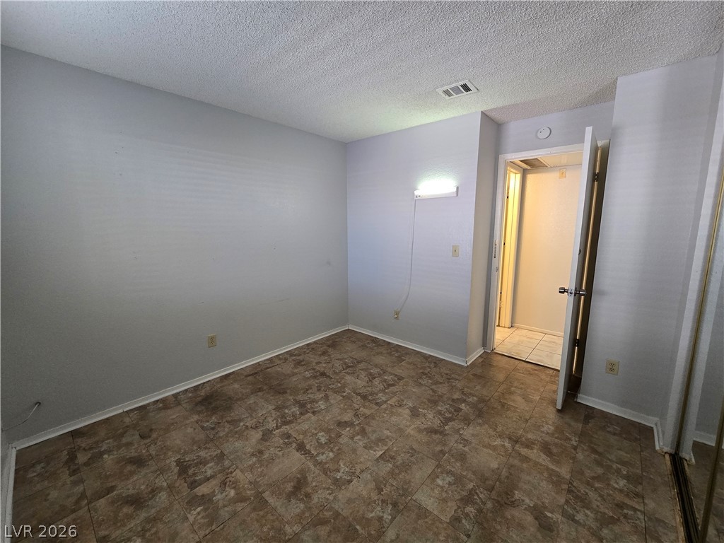 6750 Del Rey Avenue, Unit 133 Las Vegas, NV 89146 - Photo 24 of 34 Functional flooring and ample wall space characterize this practical living area.