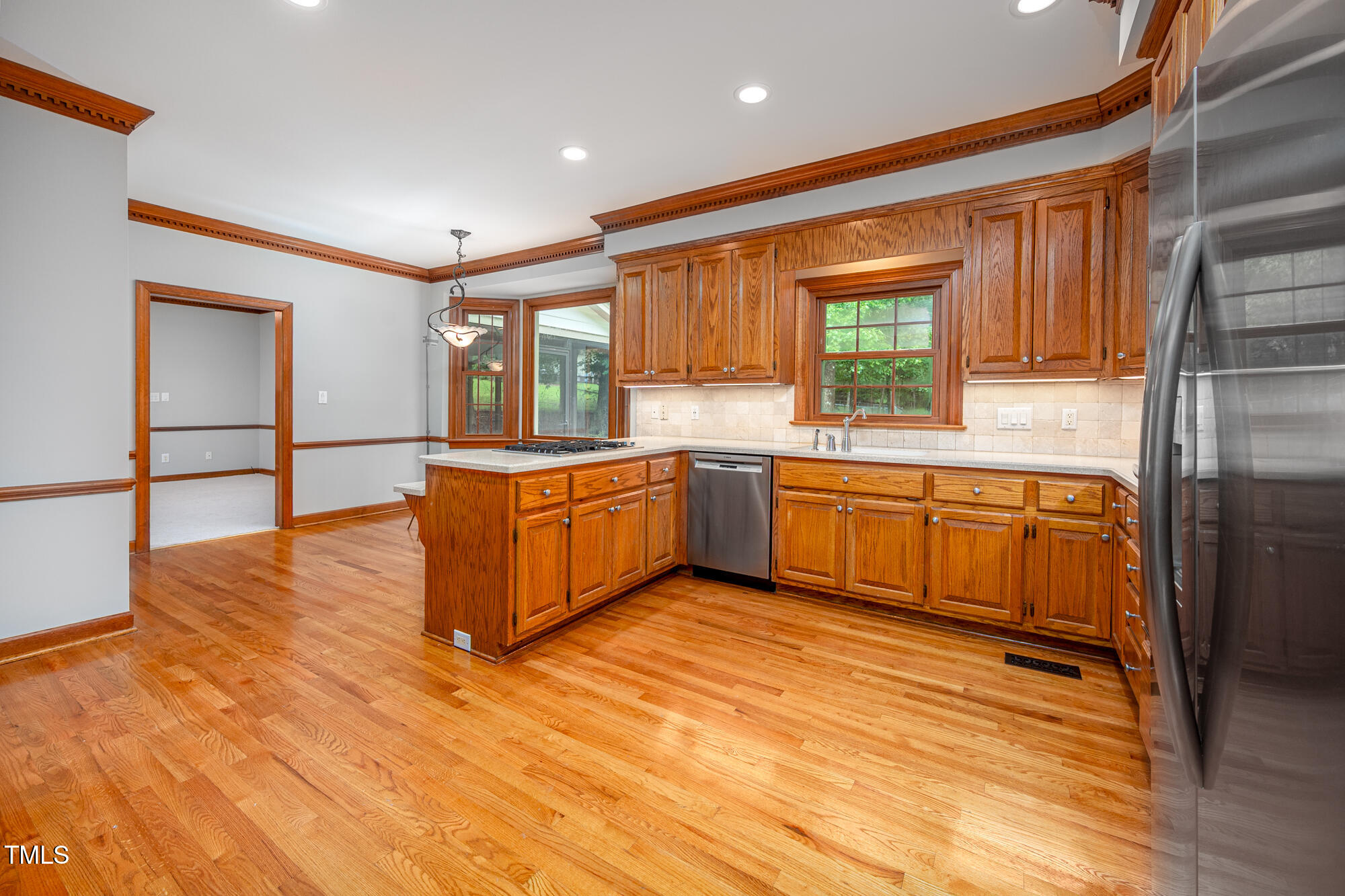 5611 Red Coach Road Durham, NC 27712 - Photo 16 of 51 a large kitchen with cabinets and wooden floor