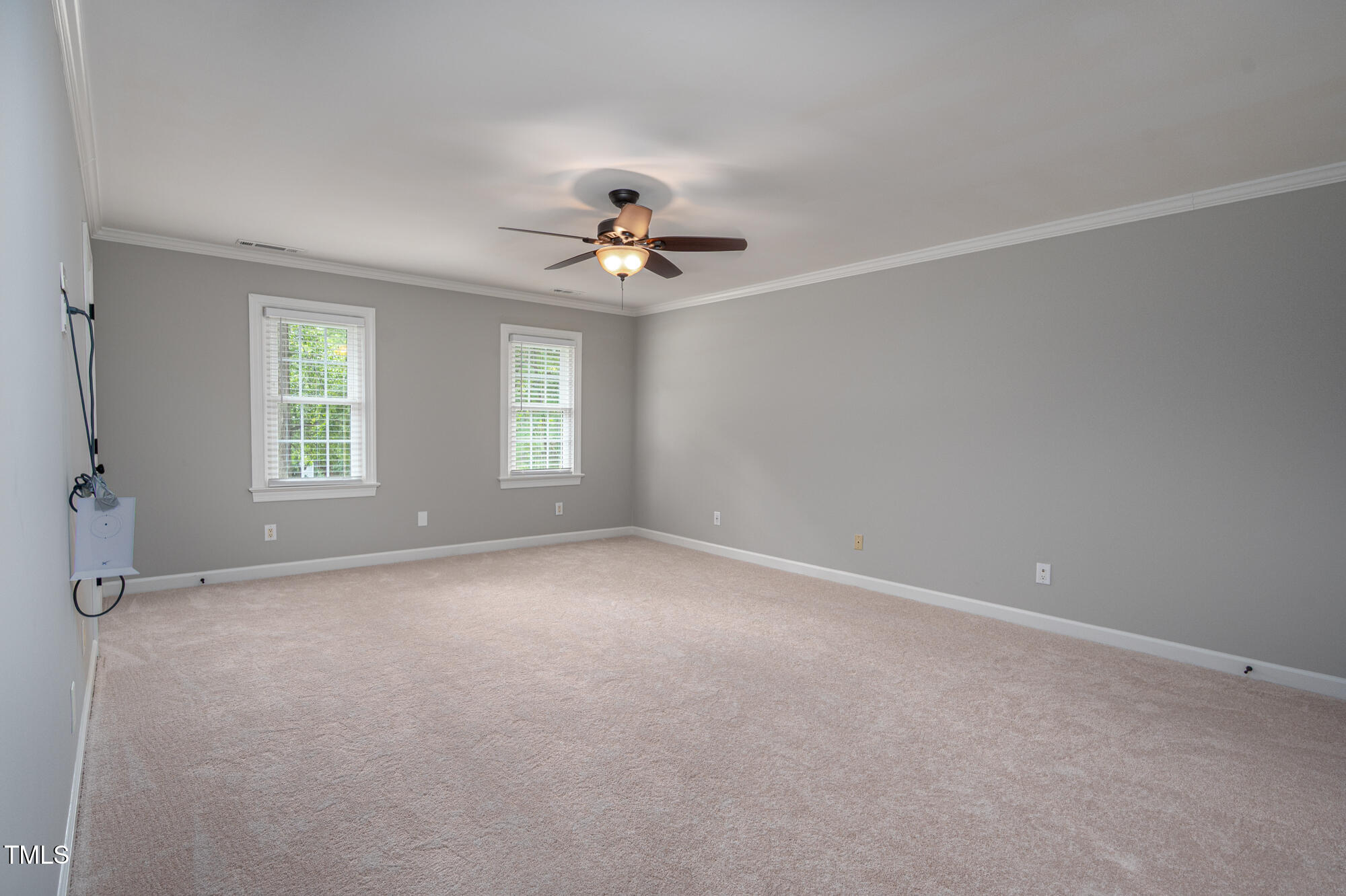 5611 Red Coach Road Durham, NC 27712 - Photo 23 of 51 an empty room with windows and chandelier fan