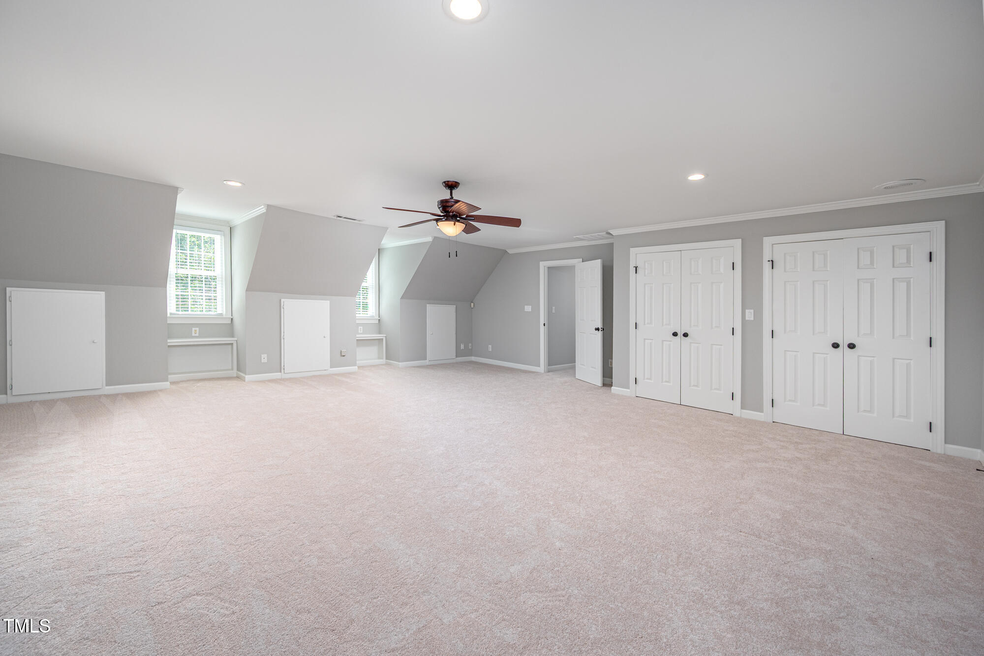 5611 Red Coach Road Durham, NC 27712 - Photo 32 of 51 a view of a big room with chandelier fan and windows