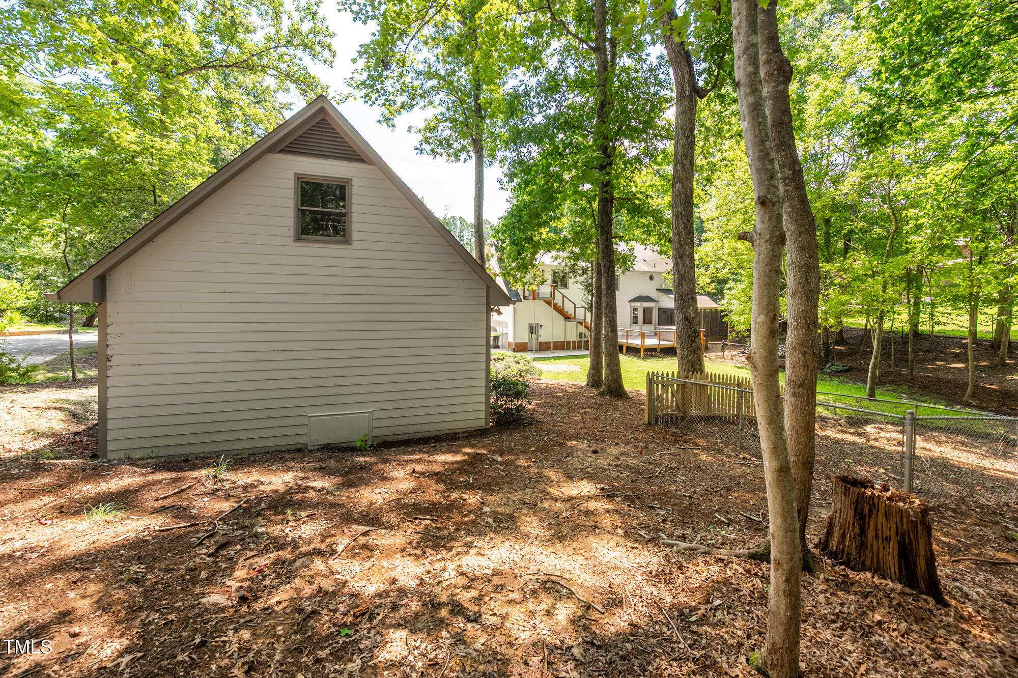 5611 Red Coach Road Durham, NC 27712 - Photo 42 of 51 a view of a barn house next to a yard with large trees