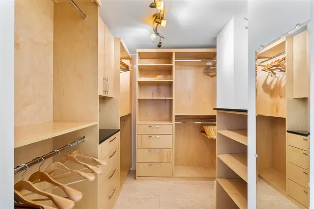 a view of walk in closet with empty racks