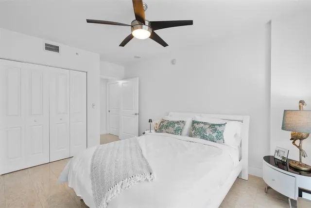 a bedroom with a bed and a lamp