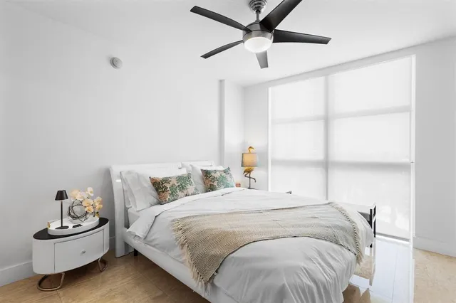 a bedroom with a bed and window