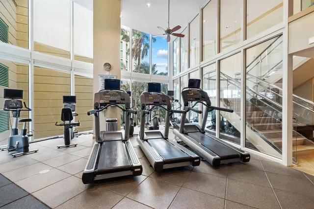 a room with furniture a flat screen tv and chairs