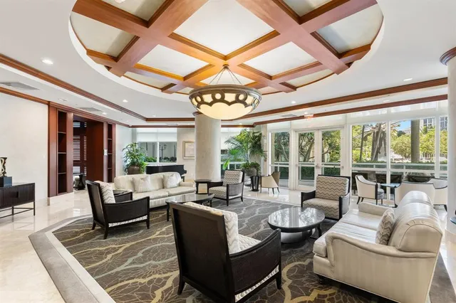 a view of a yard with plants and large trees