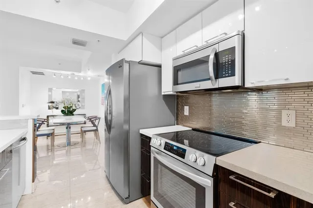 a kitchen with a stove cabinets and microwave