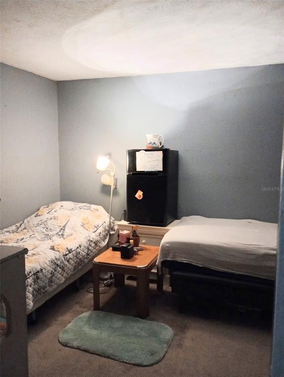 2419 Appian Avenue Spring Hill, FL 34608 - Photo 17 of 21 a bedroom with a bed and lamp