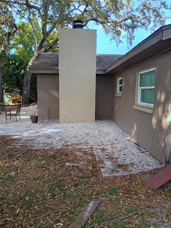 2419 Appian Avenue Spring Hill, FL 34608 - Photo 19 of 21 a backyard of a house with table and chairs