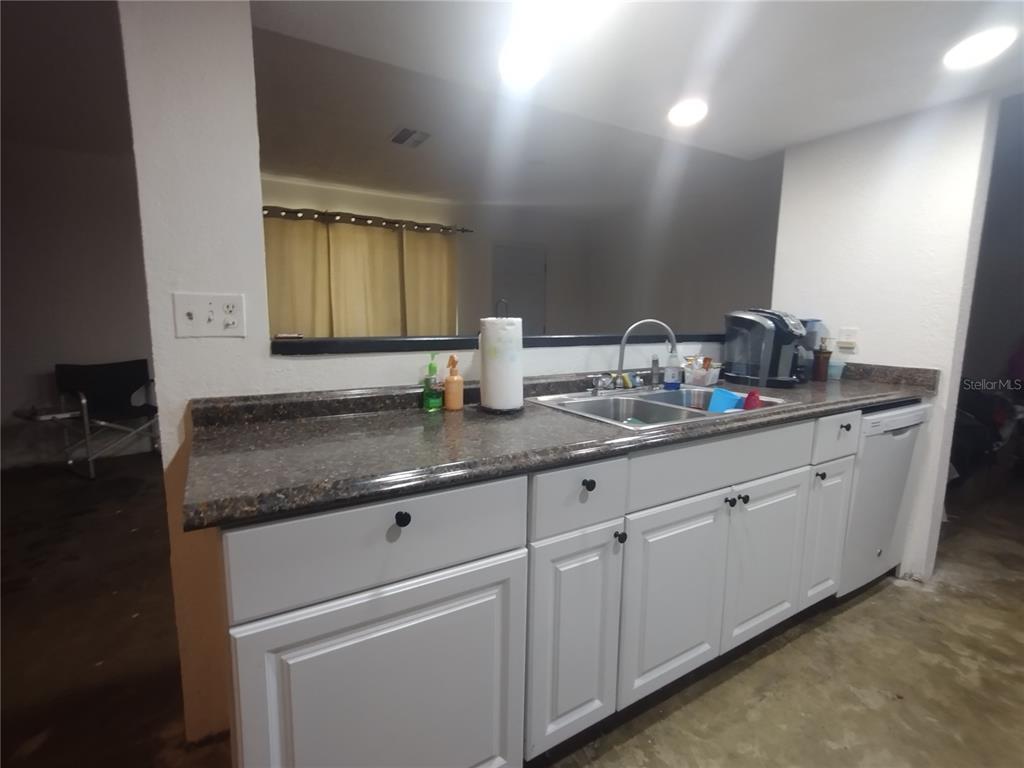 2419 Appian Avenue Spring Hill, FL 34608 - Photo 8 of 21 a kitchen with granite countertop white cabinets and a sink