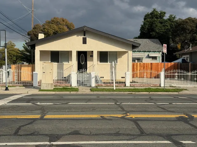 a view of a house with iron fence