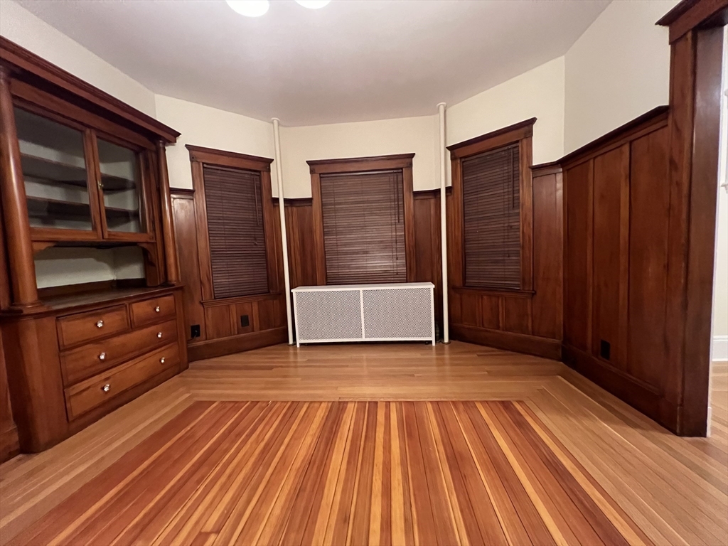 67 Commonwealth Road, Unit 1 Watertown, MA 02472 - Photo 17 of 22 a view of wooden floor and windows in a room