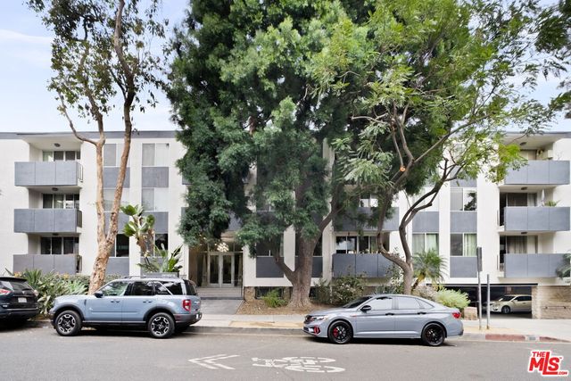 a view of cars parked in front of a building