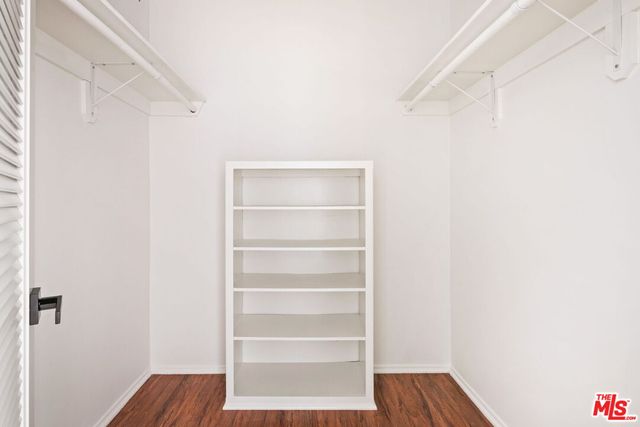 a view of walk in closet with empty racks